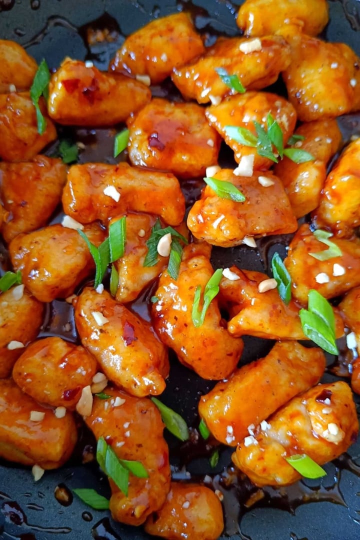 Sticky Honey Garlic Sriracha Chicken in a nonstick skillet.