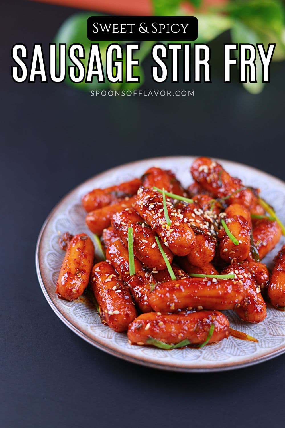 Easy spicy chicken sausage stir fry served on a plate with green onions and sesame seeds.