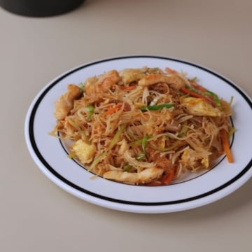 Chinese chicken mei fun home-style noodle recipe served on a white plate.