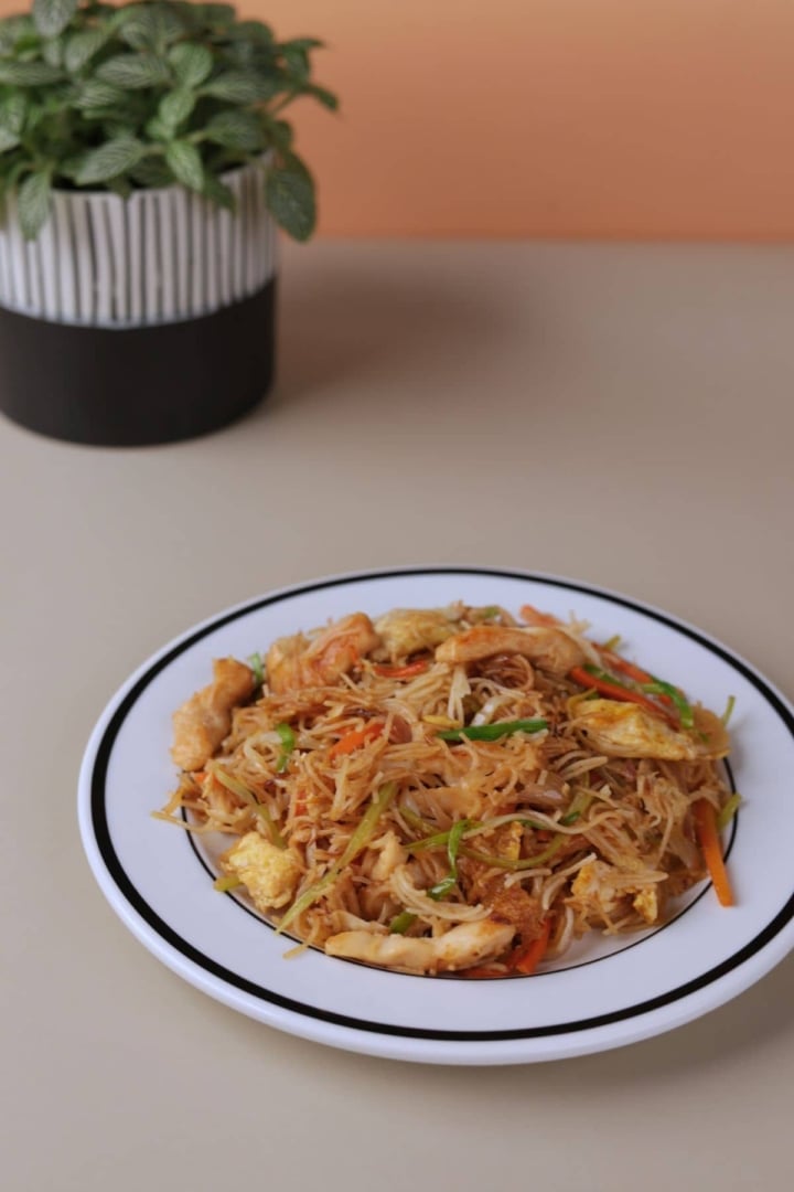 Chinese chicken mei fun home-style noodle recipe served on a white plate.

