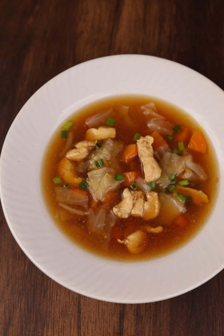 A comforting bowl of Asian style chicken and cabbage soup.