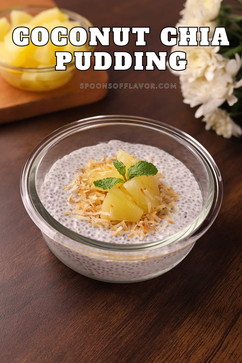Delicious coconut chia seed pudding in a glass bowl, topped with pineapple chunks and toasted coconut.