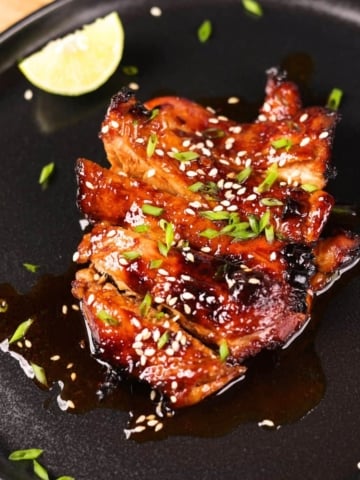 Sticky Asian marinated chicken served on a plate.