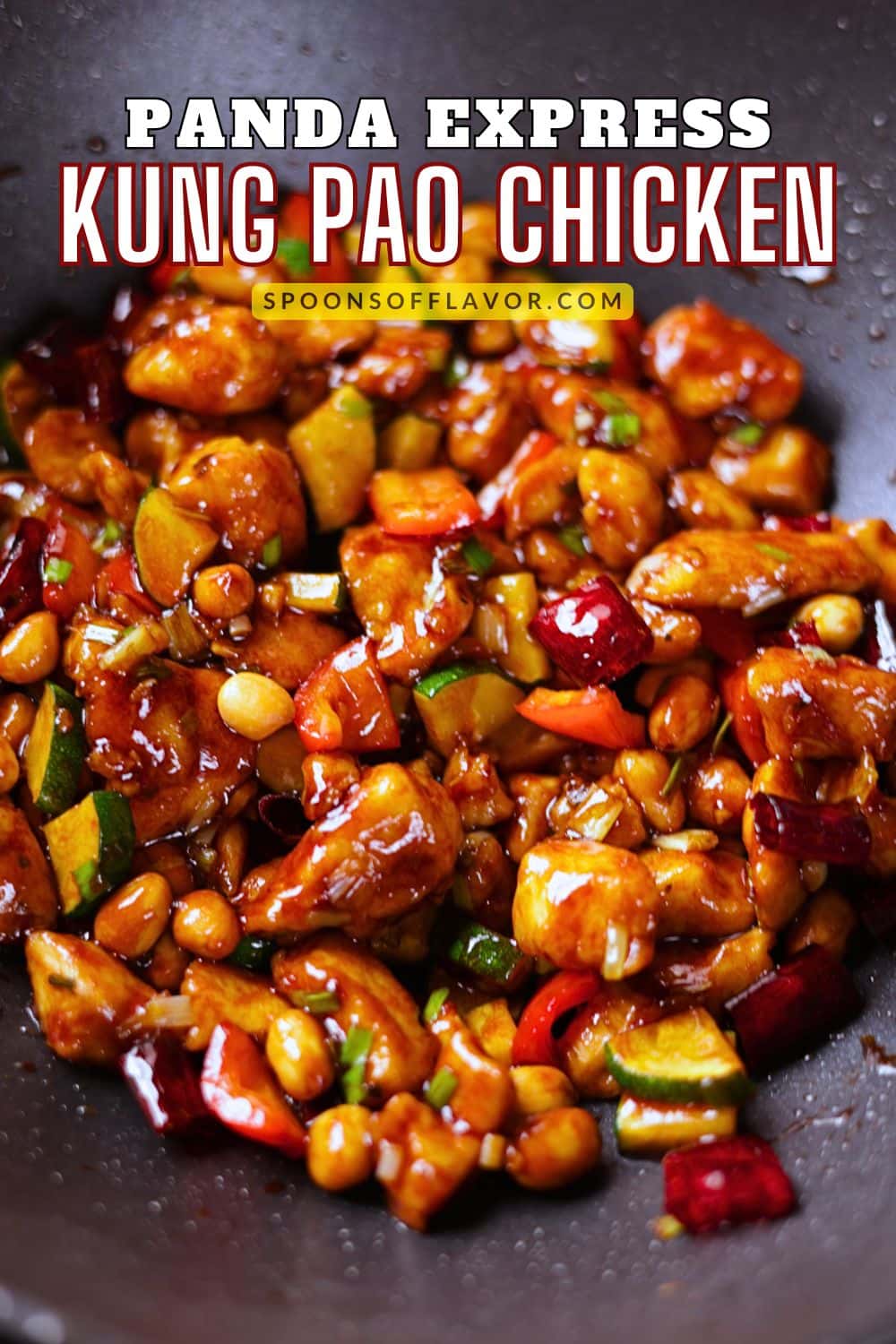 kung pao chicken coated in a glossy sauce with peanuts and dried red chilies.
