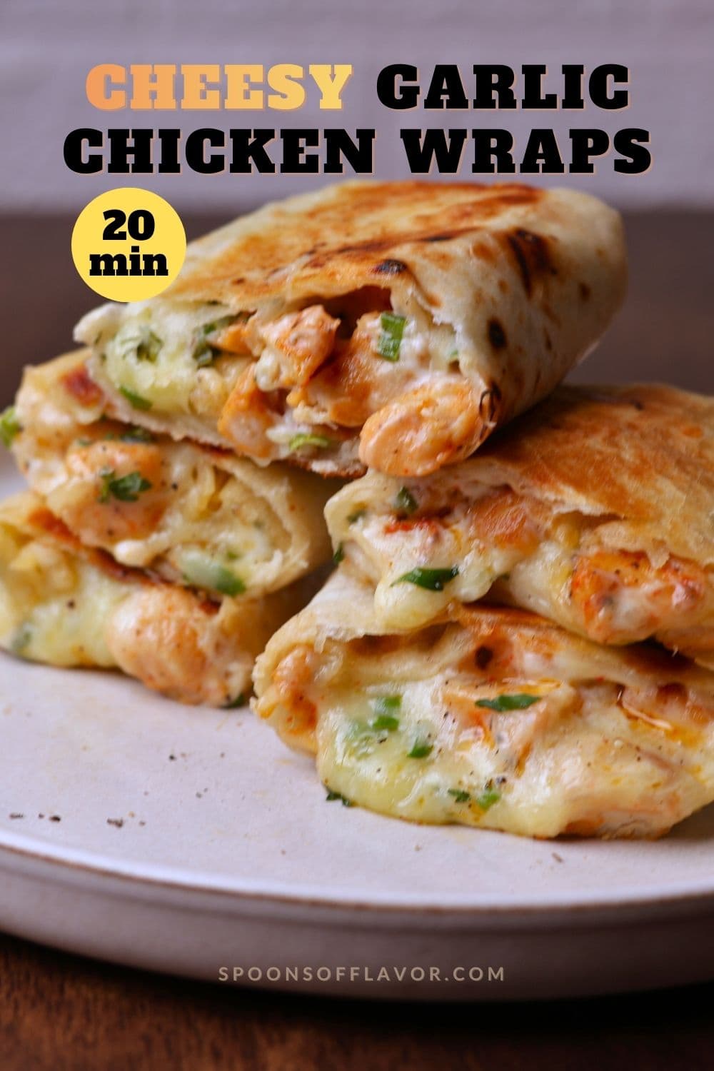 Cheesy garlic chicken wraps stack on a off white platter.