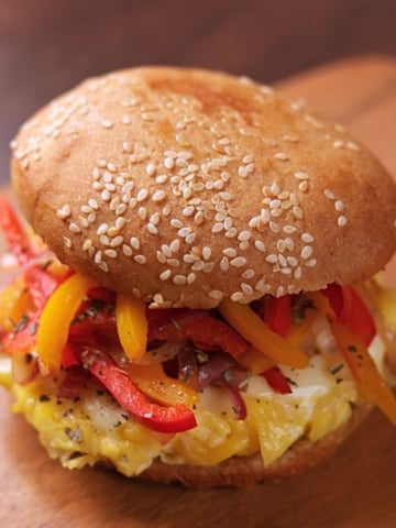 Pepper and Egg Sandwich with soft scrambled eggs, melty cheese, and sautéed peppers and onions on a lightly butter-toasted bun.