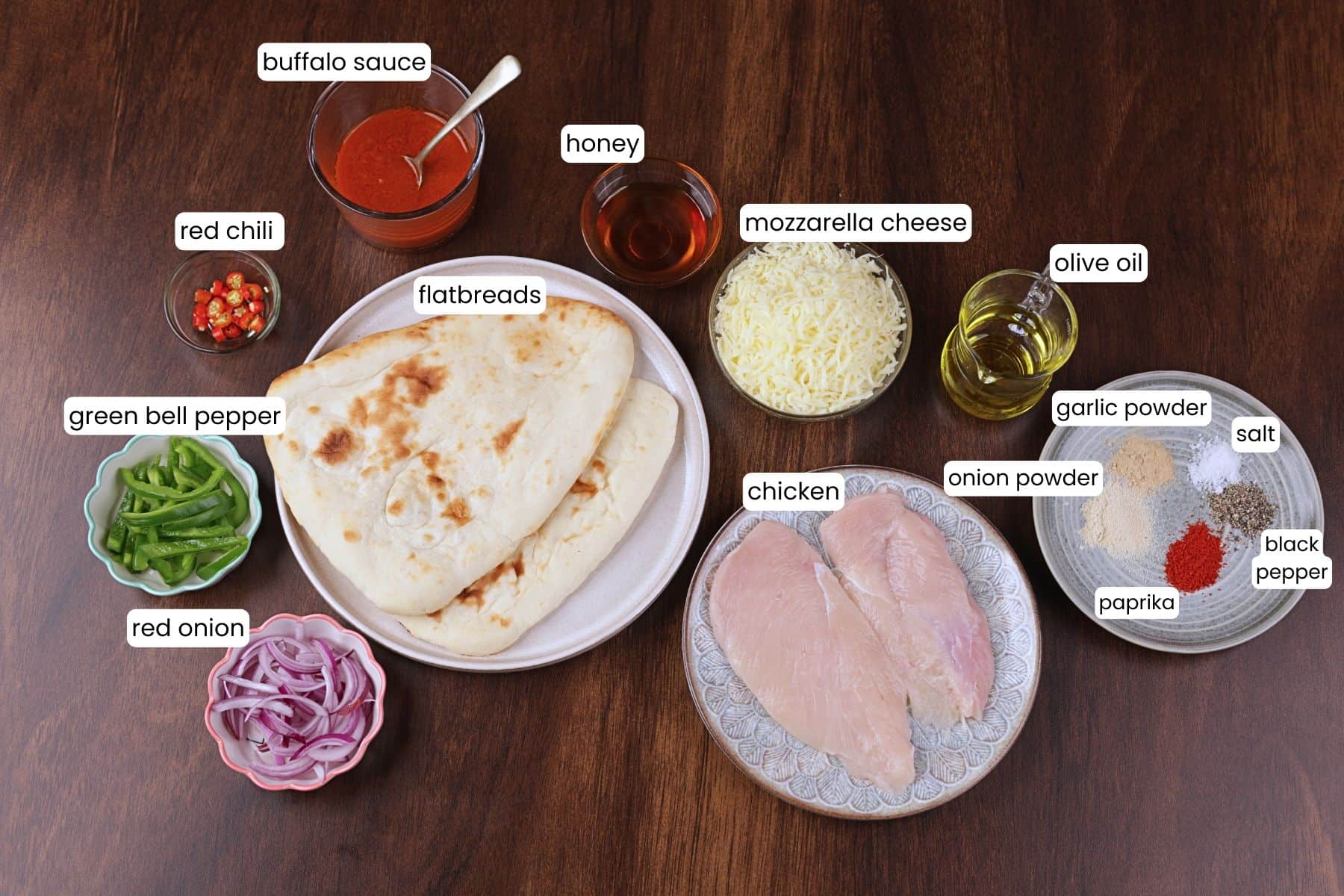 Buffalo chicken flatbread pizza ingredients including chicken, mozzarella, and buffalo sauce.
