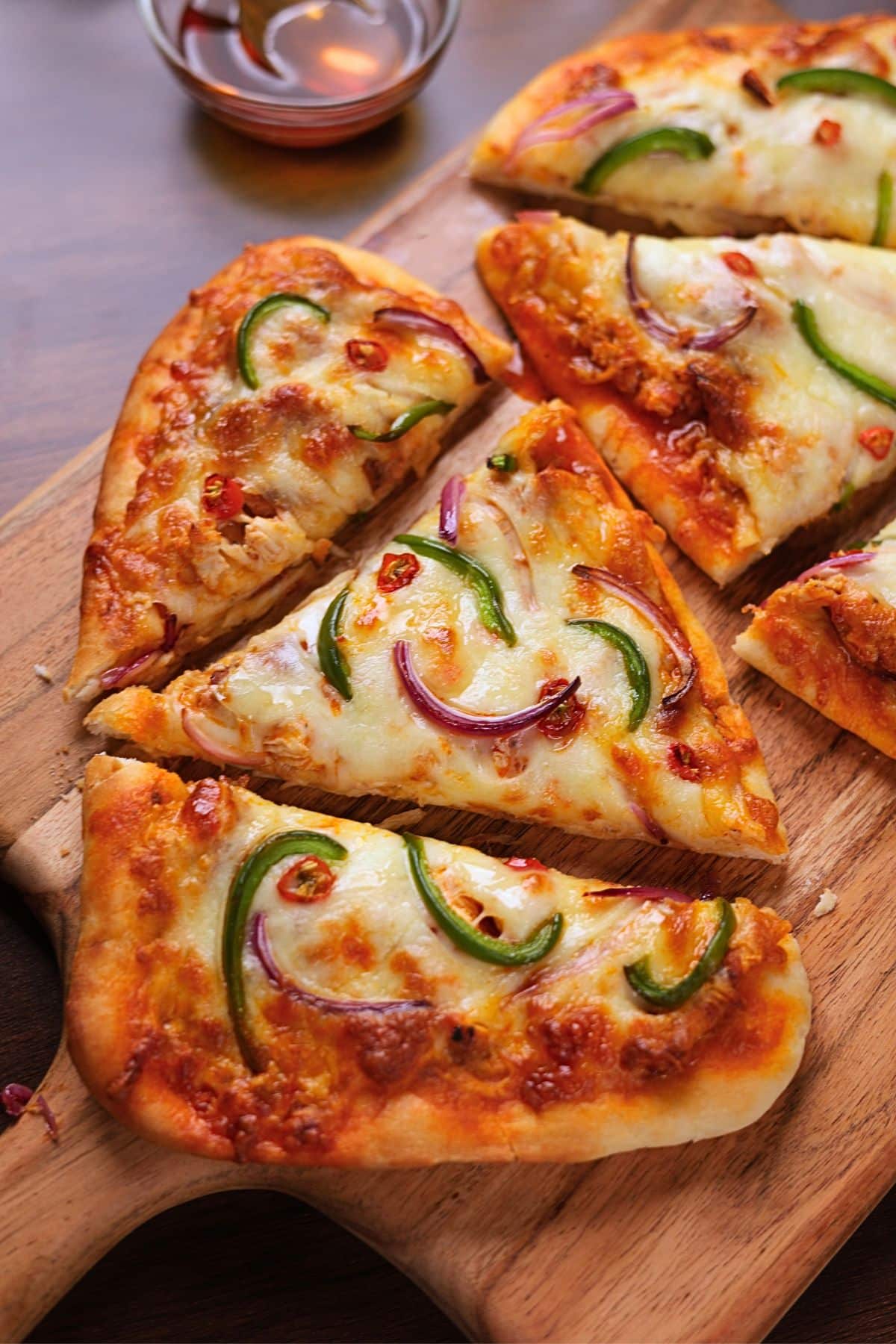 Buffalo chicken flatbread pizza sliced and ready to serve.