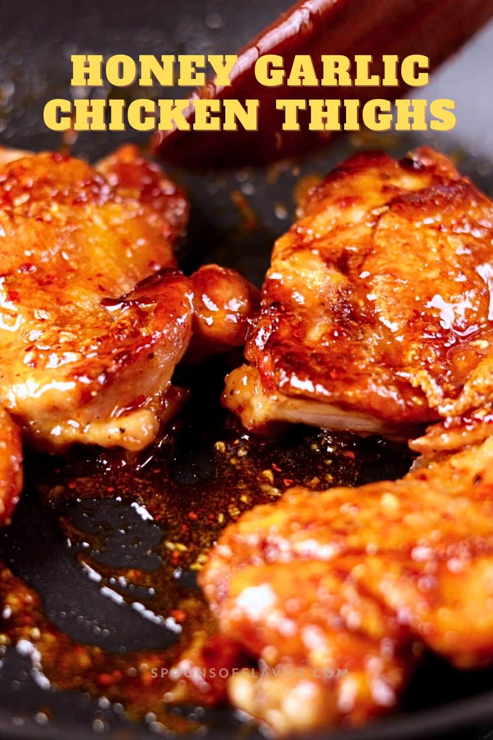 Crispy honey garlic chicken thighs served on a black platter with a glossy sticky glaze.