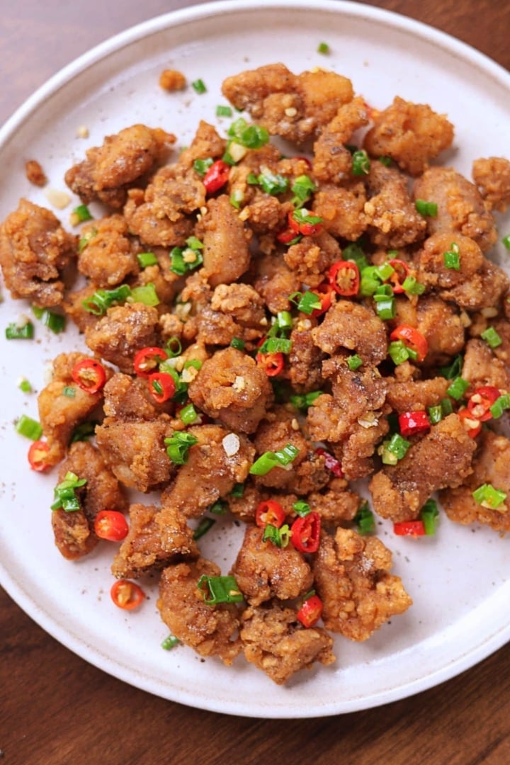Salt and pepper chicken served on a platter.