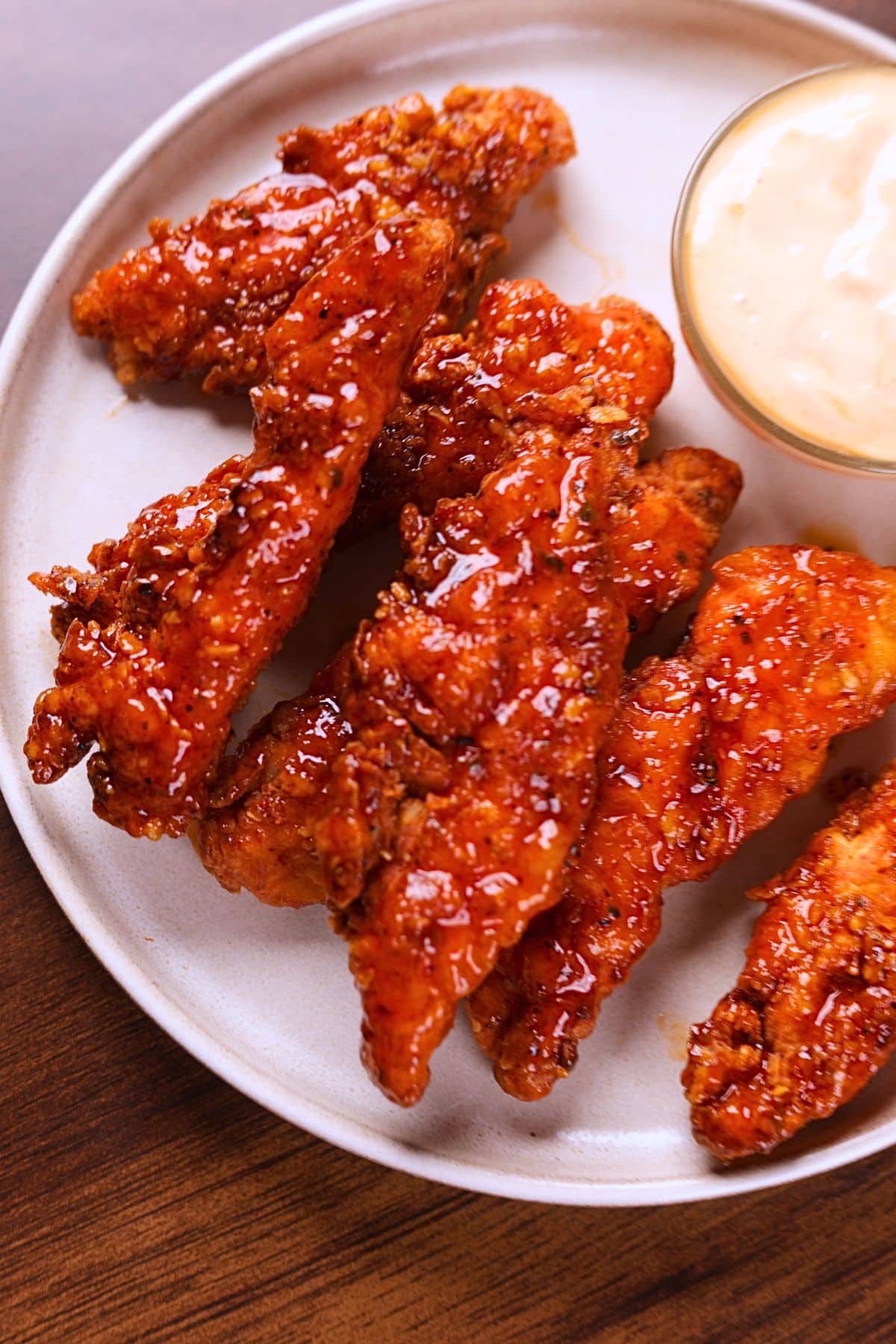 Golden crispy honey sriracha chicken tenders served with ranch dipping sauce.