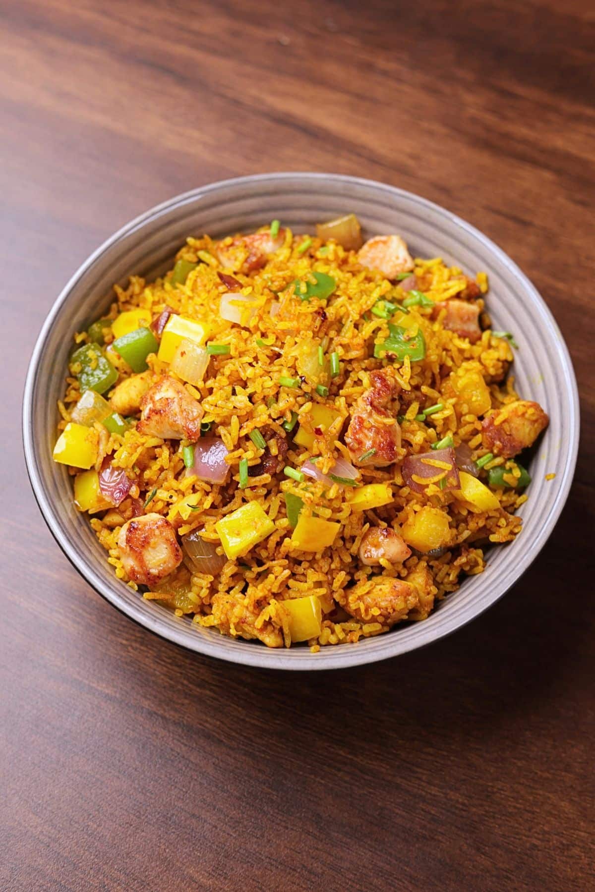 Chicken curry fried rice served in a bowl.